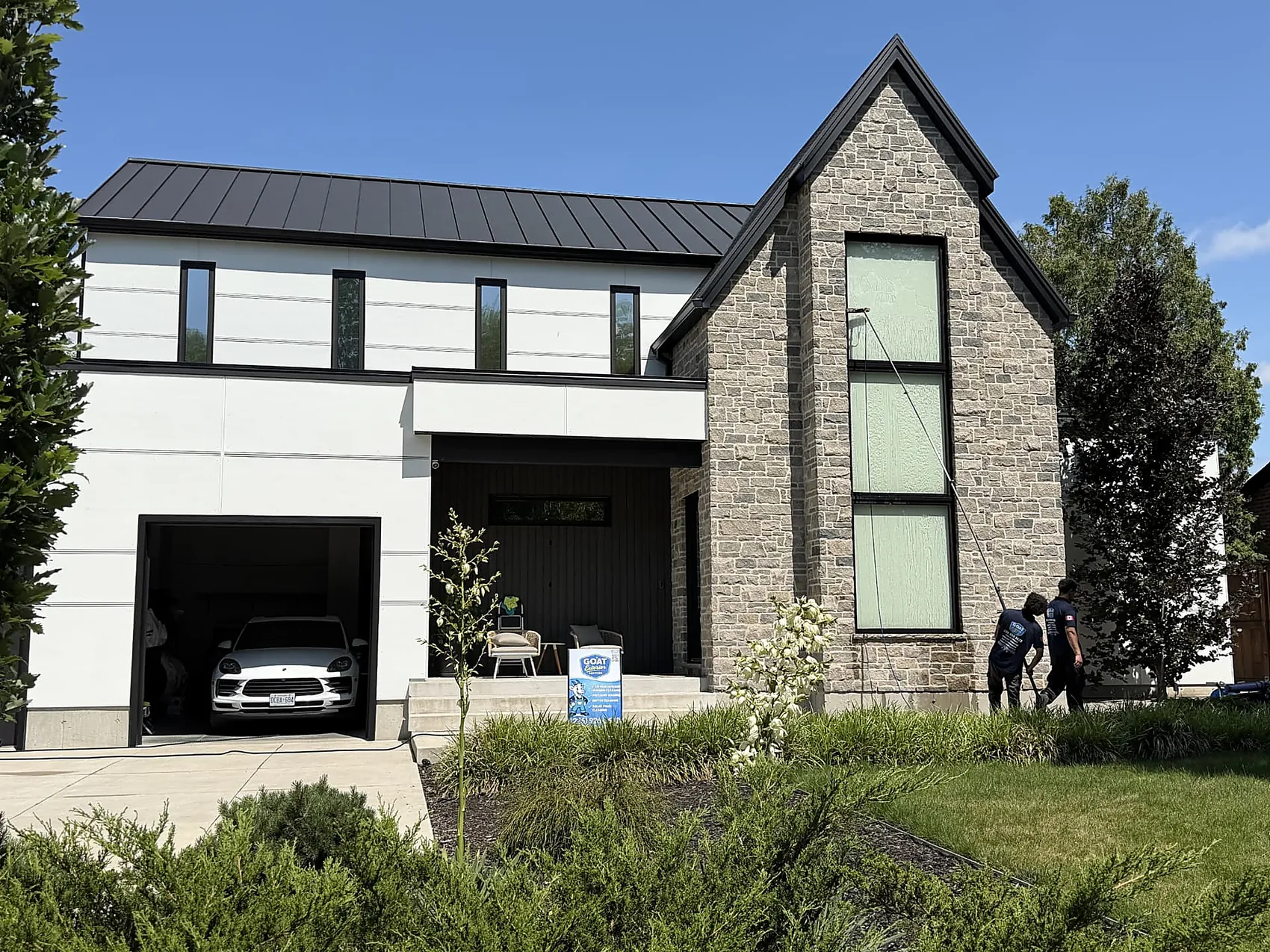 GOAT Exterior Services crew cleaning windows on a modern home in London, Ontario